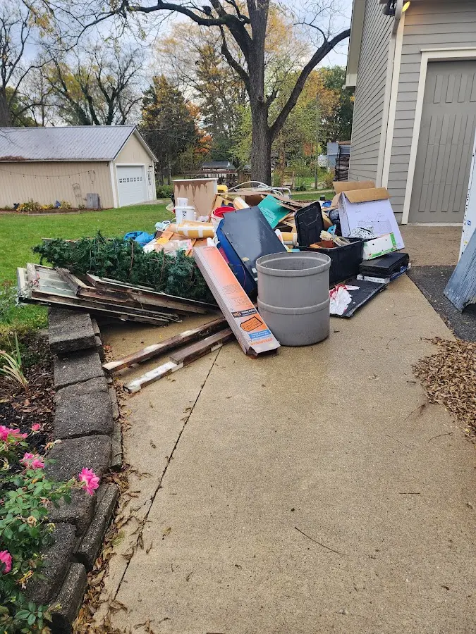 Dumpster being loaded with debris for 12 Yard Dumpster Rental in Schoharie